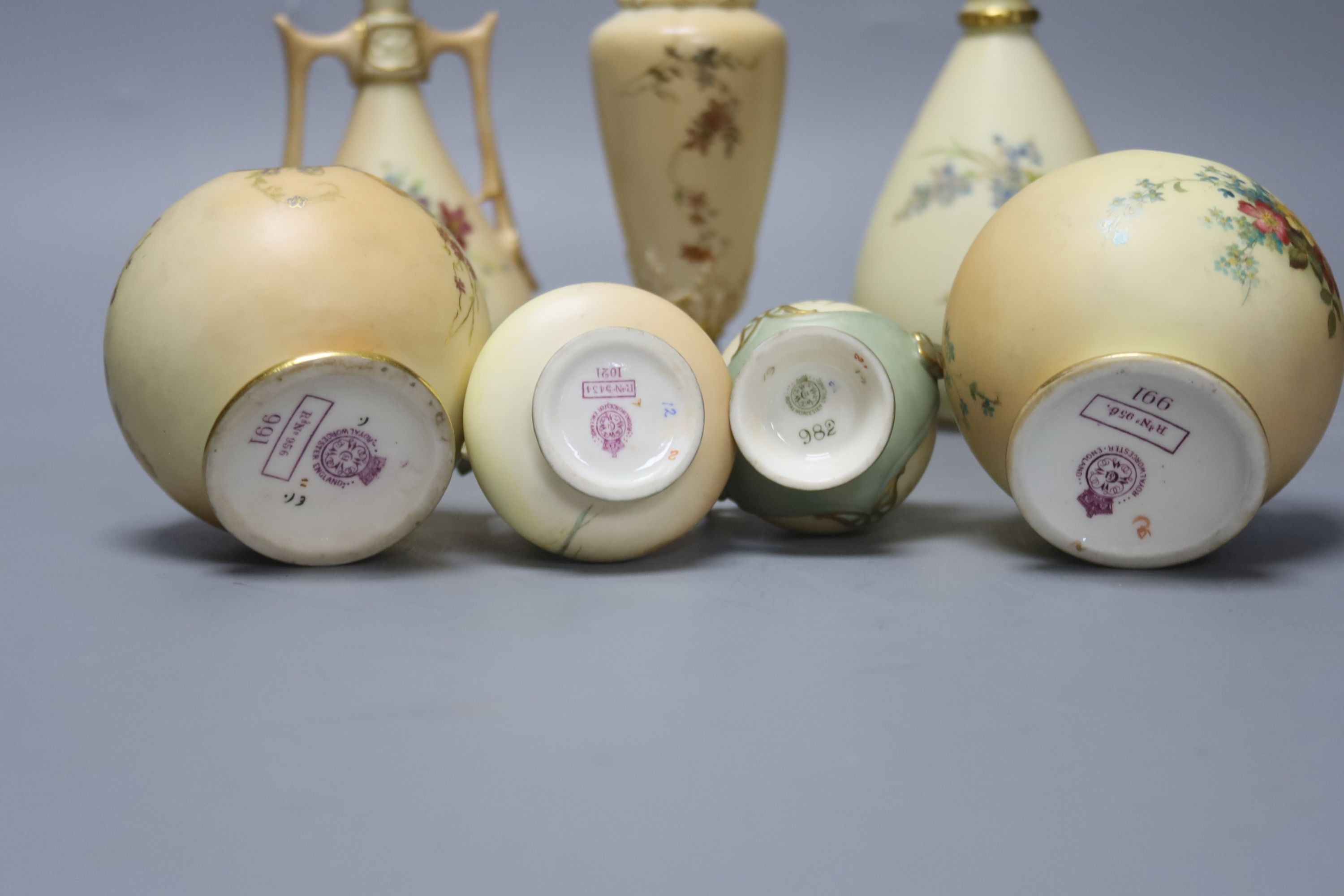 A small group of Royal Worcester blush ivory - a pair of globe pot pourri, a pair small vases and three vases, 17cm
